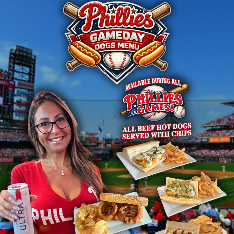 Woman in Phillies shirt holding a beer and hot dogs with chips at a baseball stadium.