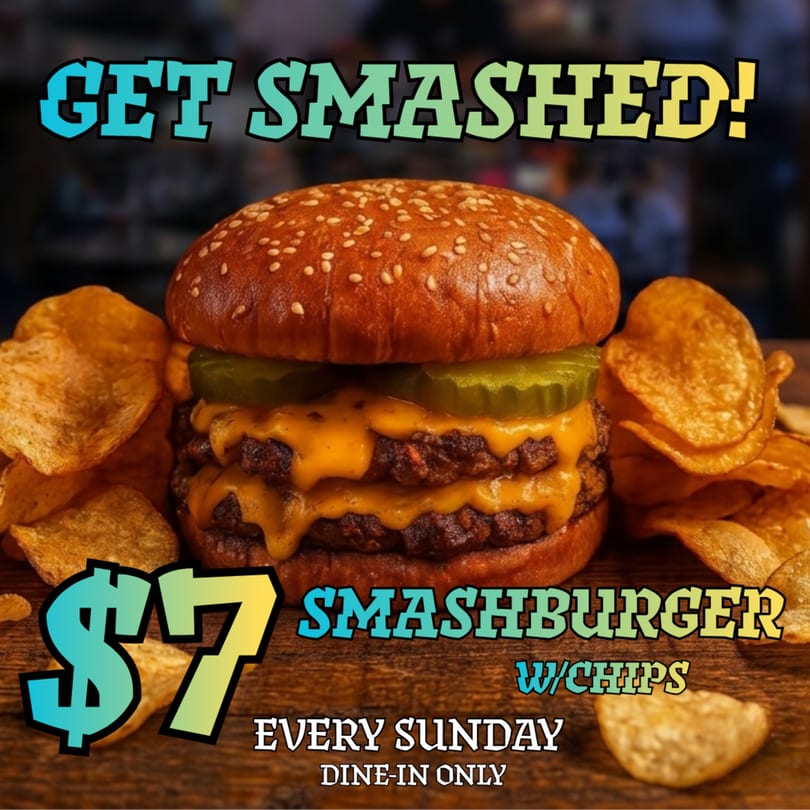 A double smashburger with melted cheese, pickles, and a side of potato chips.